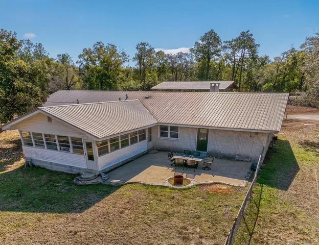 a view of a house with pool and a yard