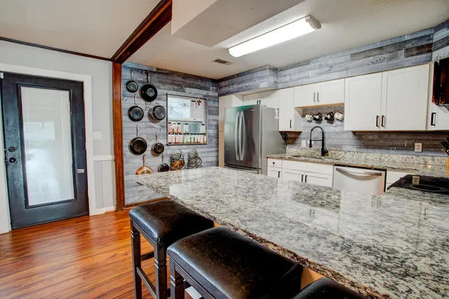 a kitchen with a table chairs and refrigerator