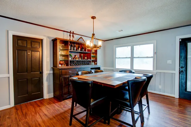 a dining room with a wooden table and chairs
