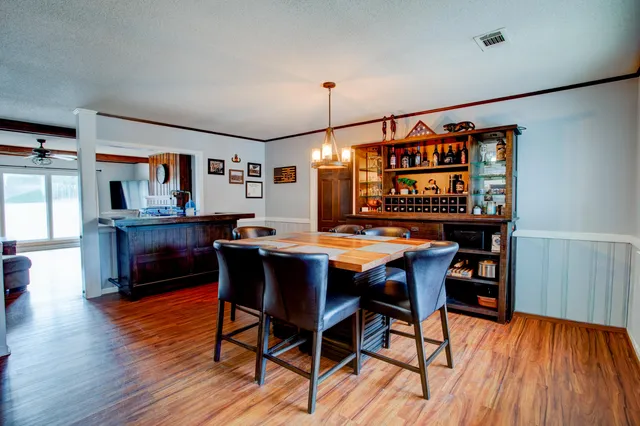 a dining room with furniture and wooden floor