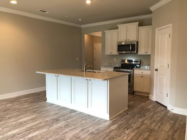 155 Stonegate Circle, Unit 69 Santa Rosa Beach, FL 32459 - Photo 10 of 31 a kitchen with stainless steel appliances a stove a refrigerator a sink a microwave and cabinets