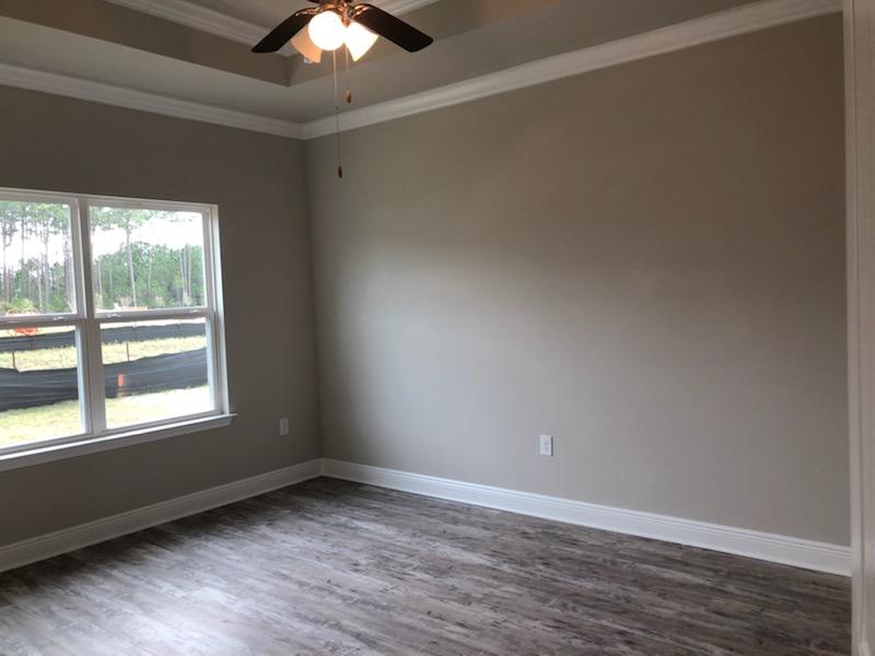 155 Stonegate Circle, Unit 69 Santa Rosa Beach, FL 32459 - Photo 11 of 31 an empty room with wooden floor and windows