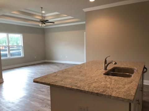 155 Stonegate Circle, Unit 69 Santa Rosa Beach, FL 32459 - Photo 12 of 31 a bathroom with a granite countertop sink a light fixture and a wooden floor