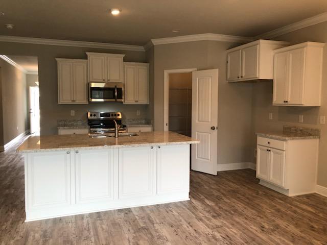 155 Stonegate Circle, Unit 69 Santa Rosa Beach, FL 32459 - Photo 13 of 31 a kitchen with stainless steel appliances a sink a stove a refrigerator and cabinets