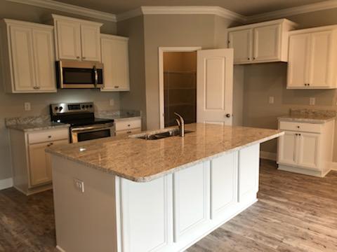 155 Stonegate Circle, Unit 69 Santa Rosa Beach, FL 32459 - Photo 14 of 31 a kitchen with stainless steel appliances granite countertop a sink stove and microwave
