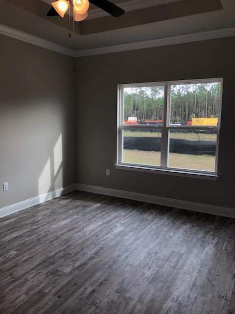 155 Stonegate Circle, Unit 69 Santa Rosa Beach, FL 32459 - Photo 20 of 31 a view of an empty room with wooden floor and a window