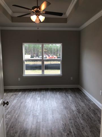 155 Stonegate Circle, Unit 69 Santa Rosa Beach, FL 32459 - Photo 25 of 31 a view of an empty room with wooden floor and a window