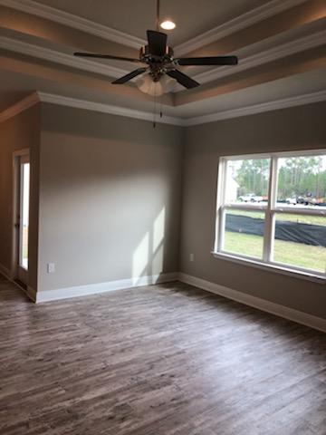 155 Stonegate Circle, Unit 69 Santa Rosa Beach, FL 32459 - Photo 26 of 31 a view of an empty room with wooden floor and a window