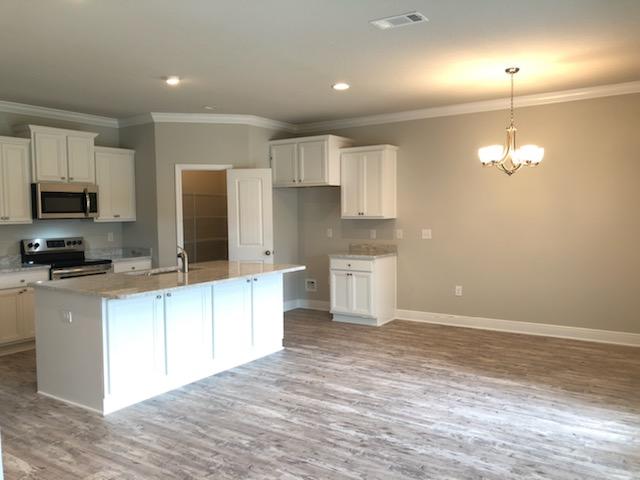 155 Stonegate Circle, Unit 69 Santa Rosa Beach, FL 32459 - Photo 8 of 31 a large kitchen with cabinets and stainless steel appliances