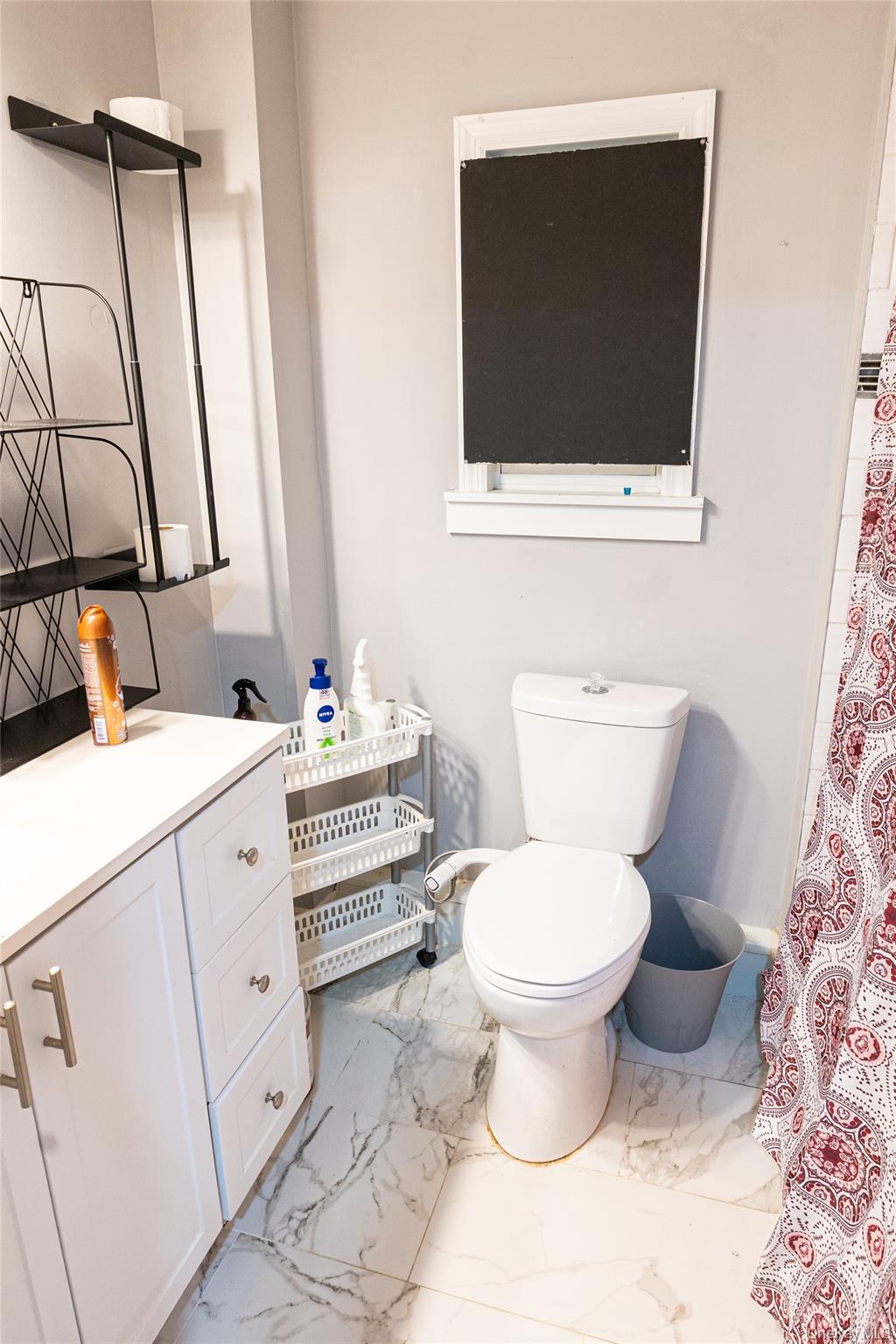 163 Orchard Road East Patchogue, NY 11772 - Photo 11 of 26 Bathroom featuring light marble finish flooring, vanity, and curtained shower