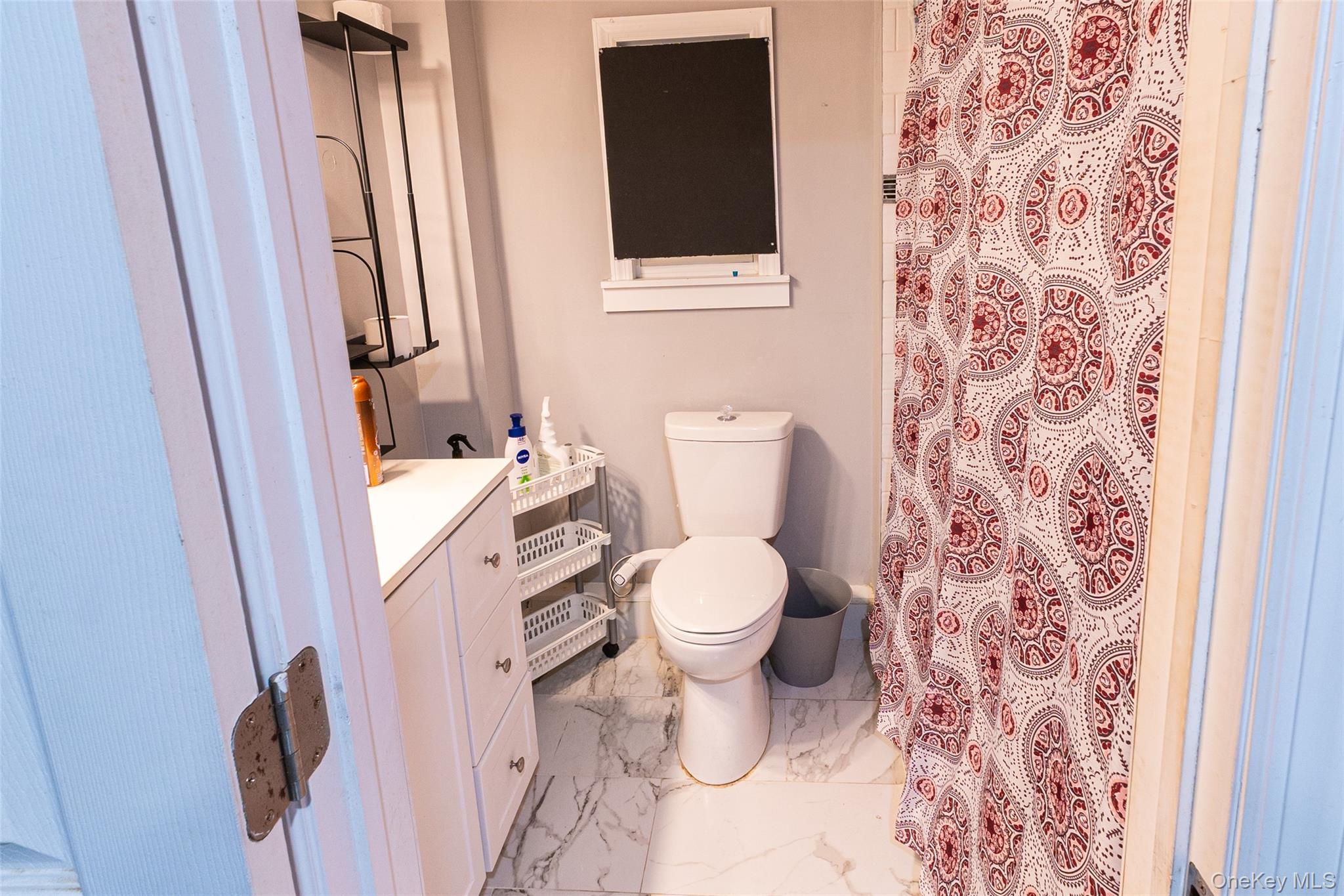 163 Orchard Road East Patchogue, NY 11772 - Photo 21 of 26 Bathroom featuring vanity, a shower with curtain, and light marble finish flooring
