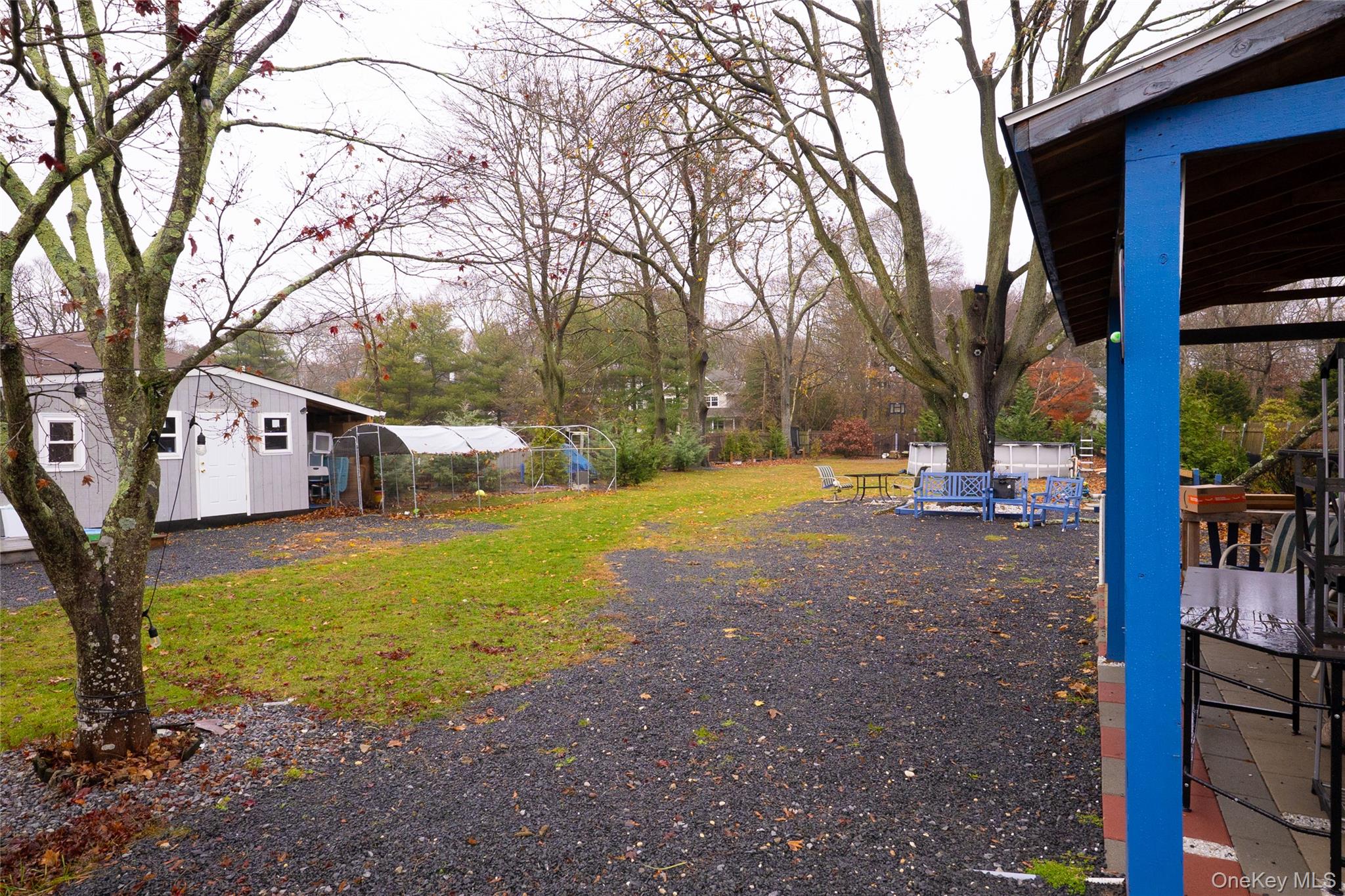 163 Orchard Road East Patchogue, NY 11772 - Photo 24 of 26 View of grassy yard featuring an outbuilding and a greenhouse