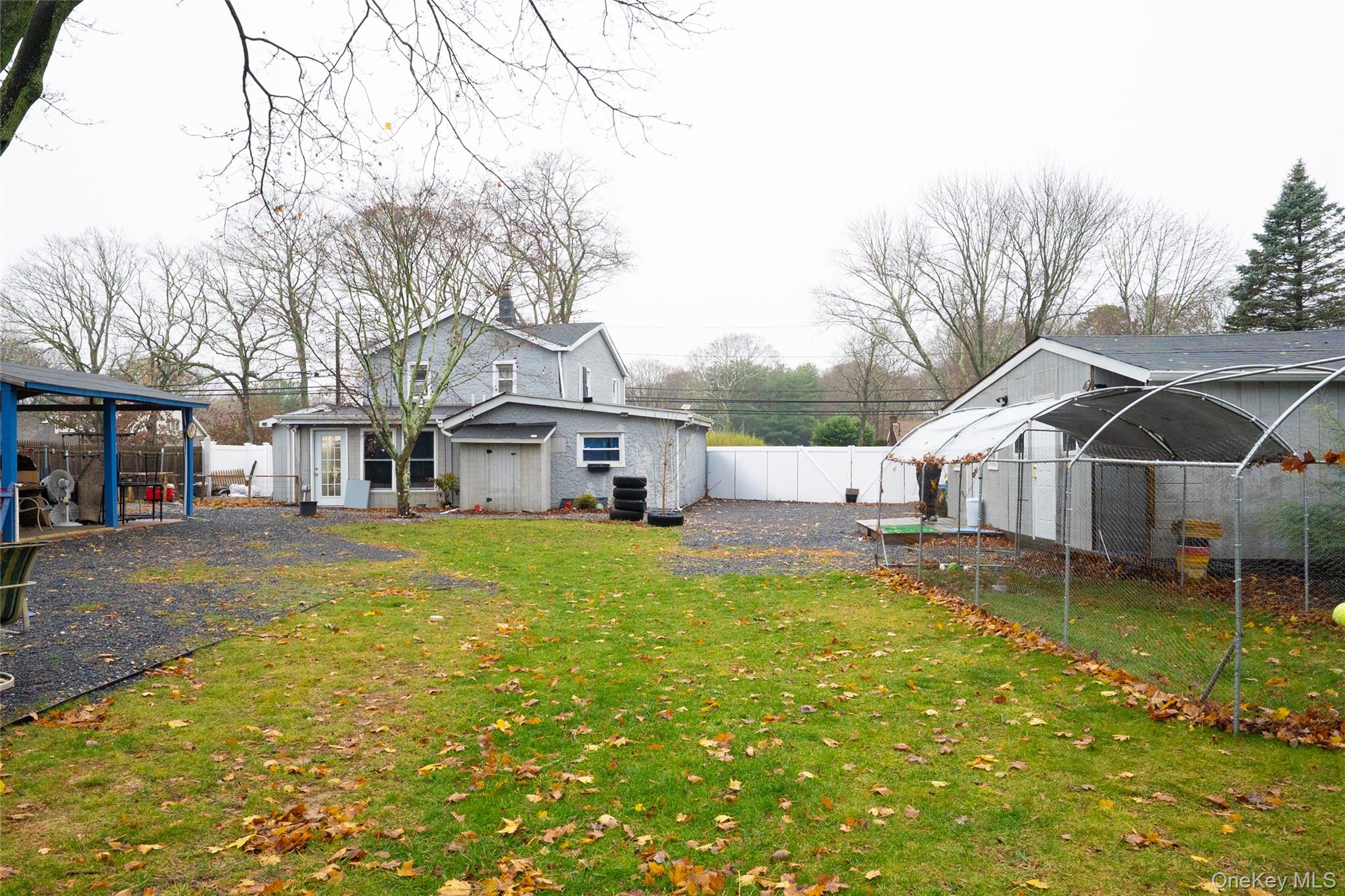 163 Orchard Road East Patchogue, NY 11772 - Photo 25 of 26 Rear view of house with a fenced backyard and an outbuilding