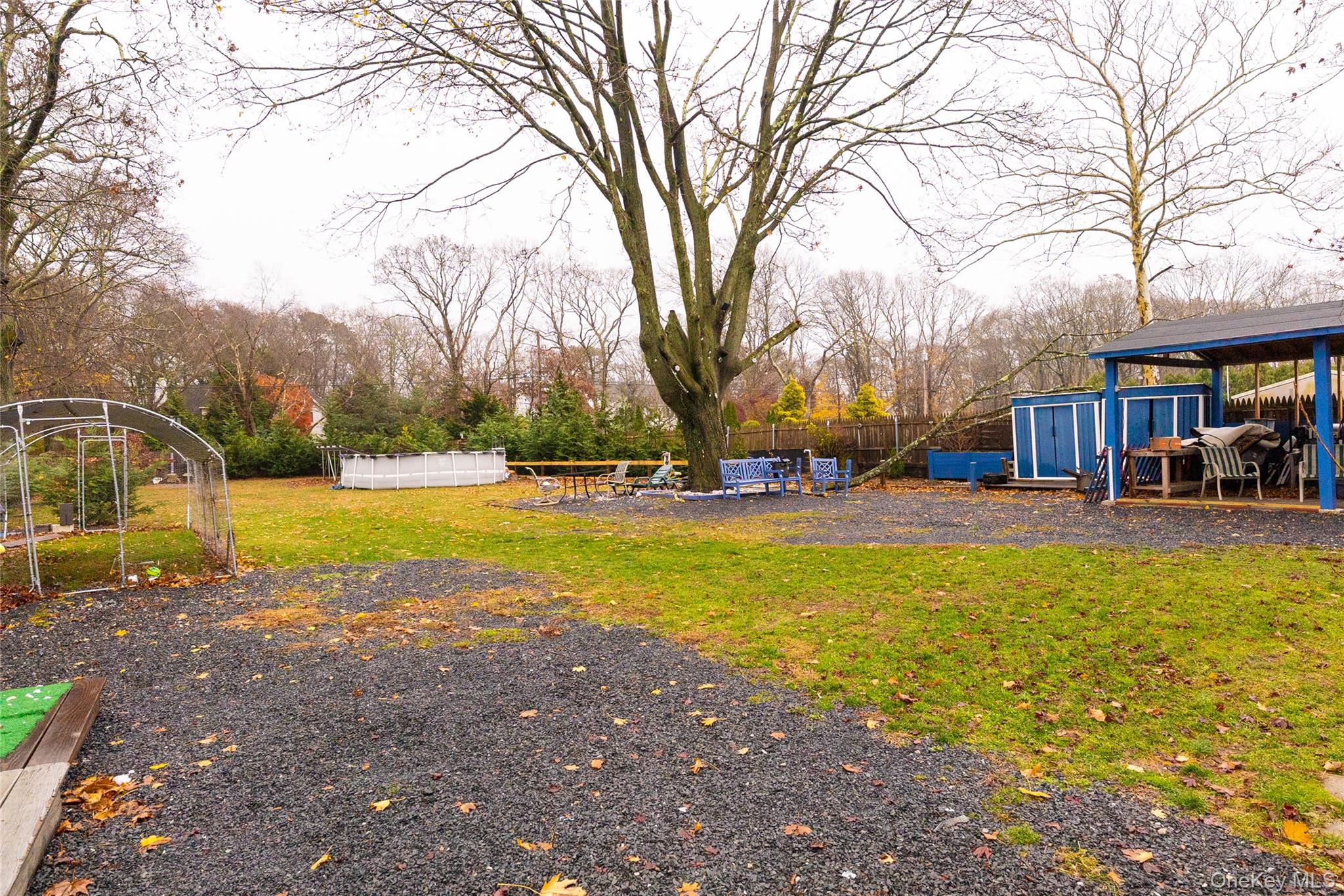 163 Orchard Road East Patchogue, NY 11772 - Photo 26 of 26 View of yard with a trampoline and an outbuilding