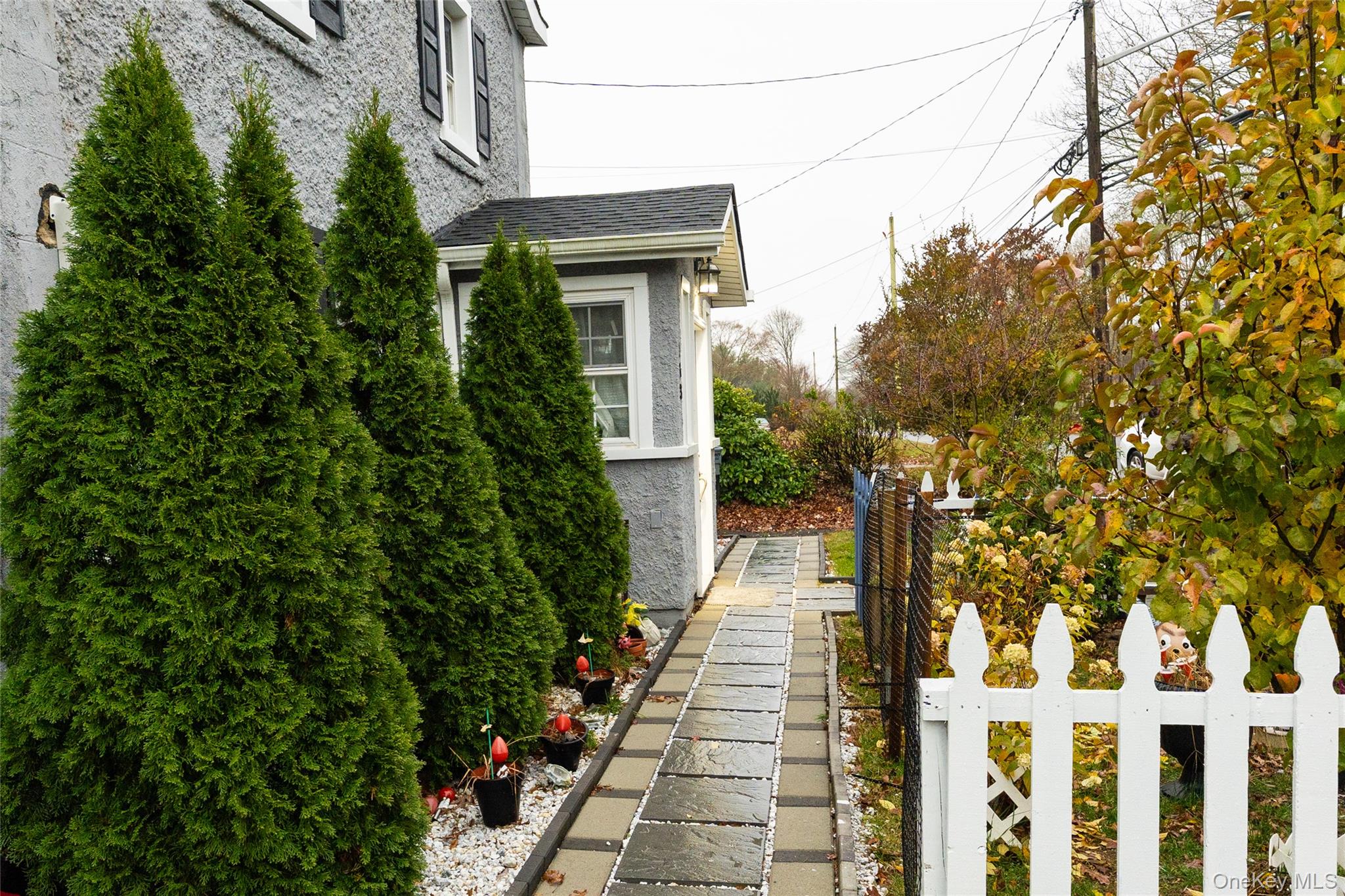 163 Orchard Road East Patchogue, NY 11772 - Photo 4 of 26 View of home's exterior with stucco siding and a shingled roof