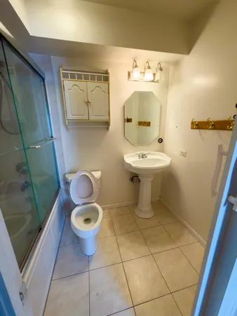 a bathroom with a sink a toilet and mirror