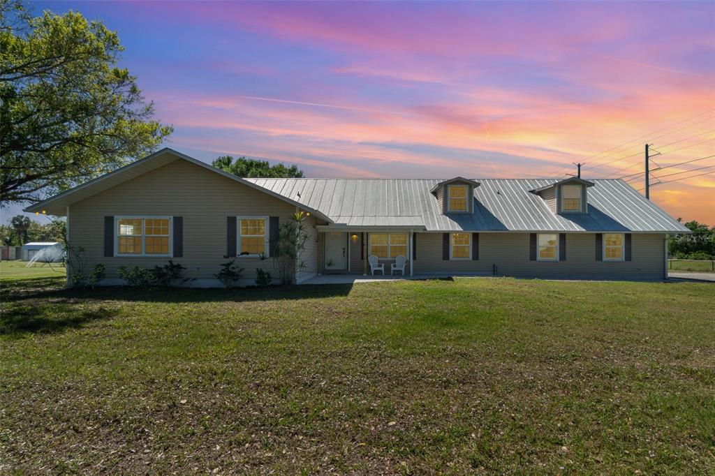 7055 Riverside Drive Punta Gorda, FL 33982 - Photo 1 of 1 a front view of a house with garden