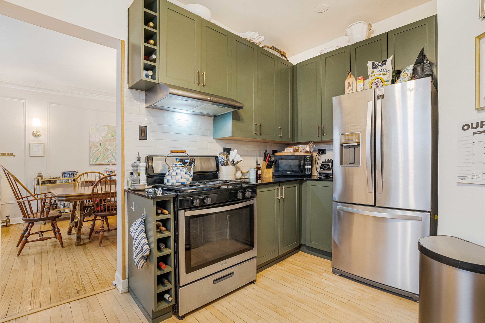 718 West Gordon Terrace, Unit 1F Chicago, IL 60613 - Photo 8 of 13 a kitchen with stainless steel appliances granite countertop a stove a refrigerator and a refrigerator