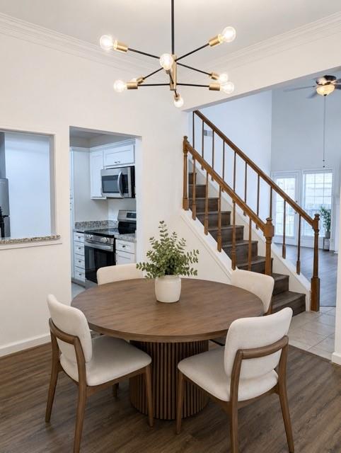 12680 Hillcrest Road, Unit 4101 Dallas, TX 75230 - Photo 7 of 37 Contemporary sputnik chandelier illuminating a dining area with wood-finish flooring *Virtually Staged*