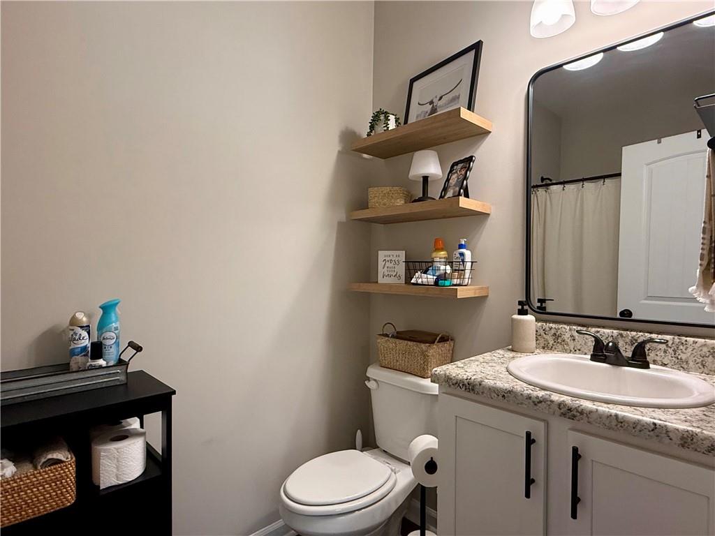 1776 Pleasant Grove Road Temple, GA 30179 - Photo 20 of 45 a bathroom with a granite countertop sink a toilet and a shower