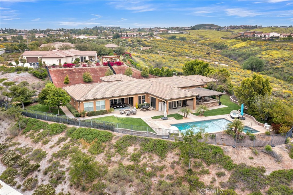 an aerial view of residential houses with outdoor space and trees