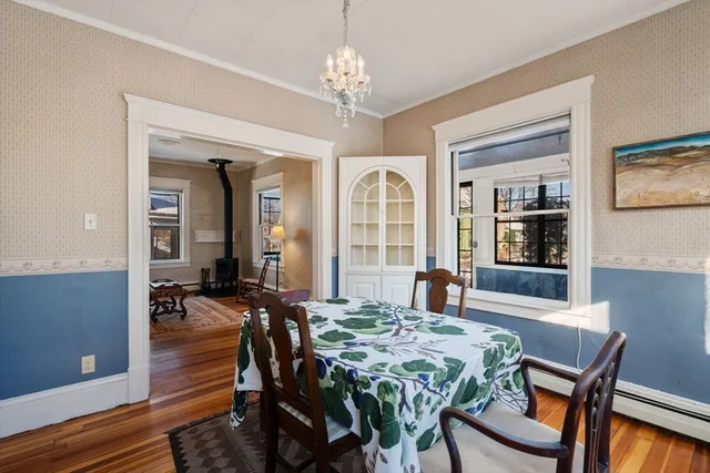 a view of a dining room with furniture and chandelier