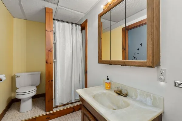 a bathroom with a sink toilet and shower