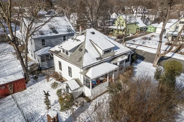 an aerial view of a house with a yard