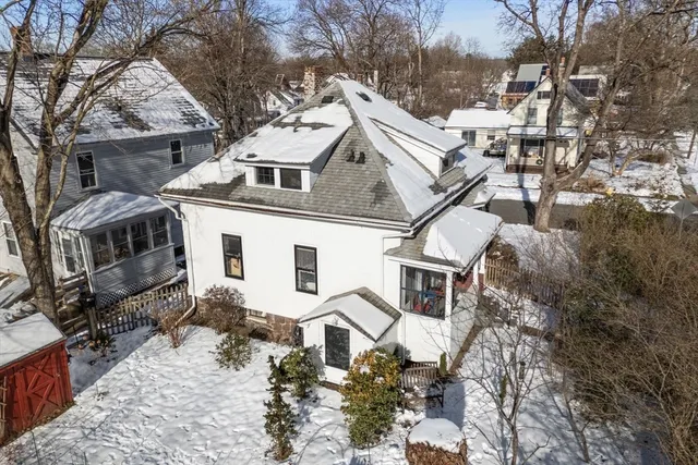 a view of a house with a yard covered with snow