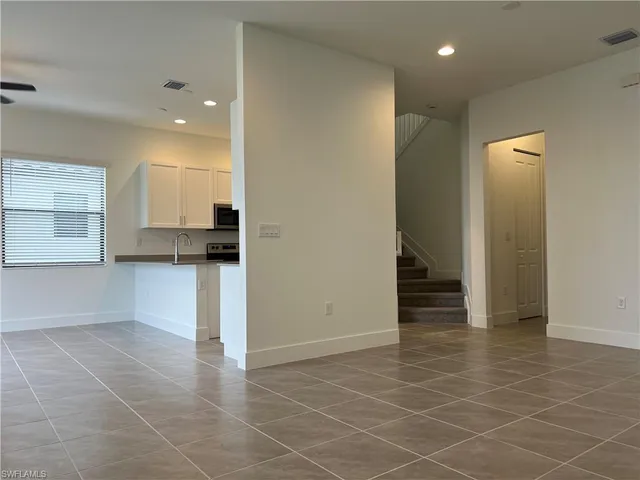 a view of a kitchen with an empty space and a window