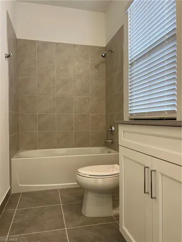 a bathroom with a toilet and a bathtub