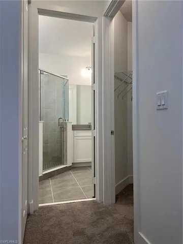 a bathroom with a shower and a sink
