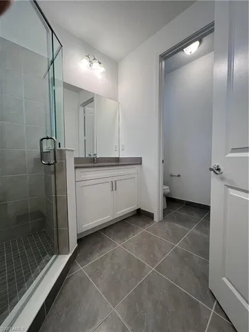 a bathroom with a shower and a sink
