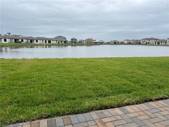 a view of a lake with houses in the back