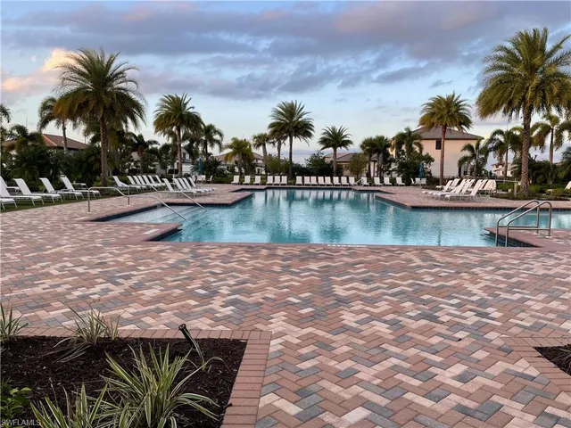 a view of a lake with palm trees