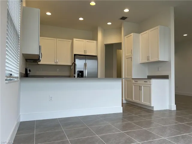 a kitchen with stainless steel appliances a refrigerator sink and cabinets