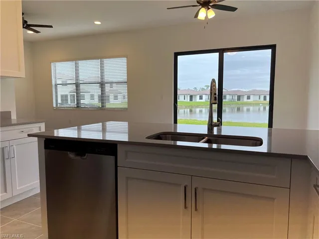 a kitchen with a sink and large window