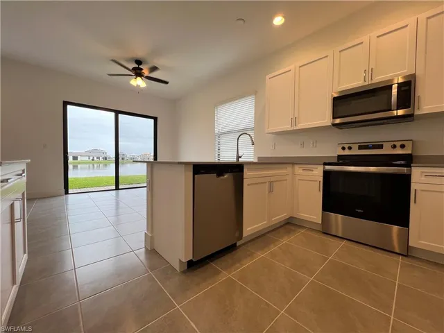 a kitchen with stainless steel appliances a stove a sink a microwave and cabinets