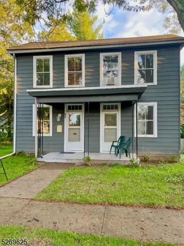 a front view of a house with garden and porch