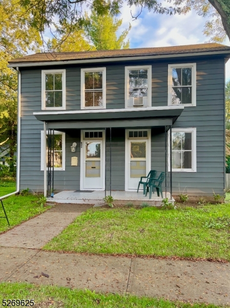 a front view of a house with garden and porch
