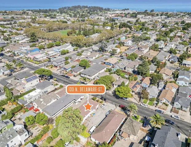 an aerial view of residential houses with outdoor space