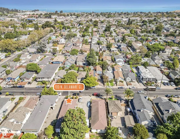 an aerial view of residential houses with outdoor space