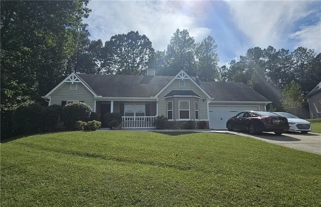 a front view of a house with a garden