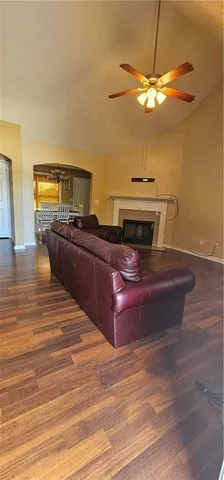 a room with a chandelier and wooden floor
