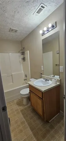 a bathroom with a sink a toilet and mirror