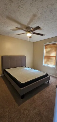 a bedroom with a bed and window