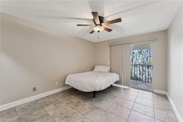 a bedroom with a bed and a ceiling fan