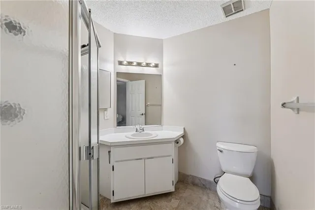 a bathroom with a glass shower door