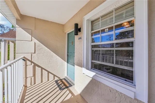a view of staircase with wooden floor and windows