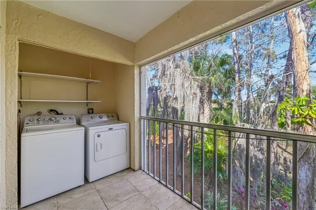 a dining room with furniture and a floor to ceiling window